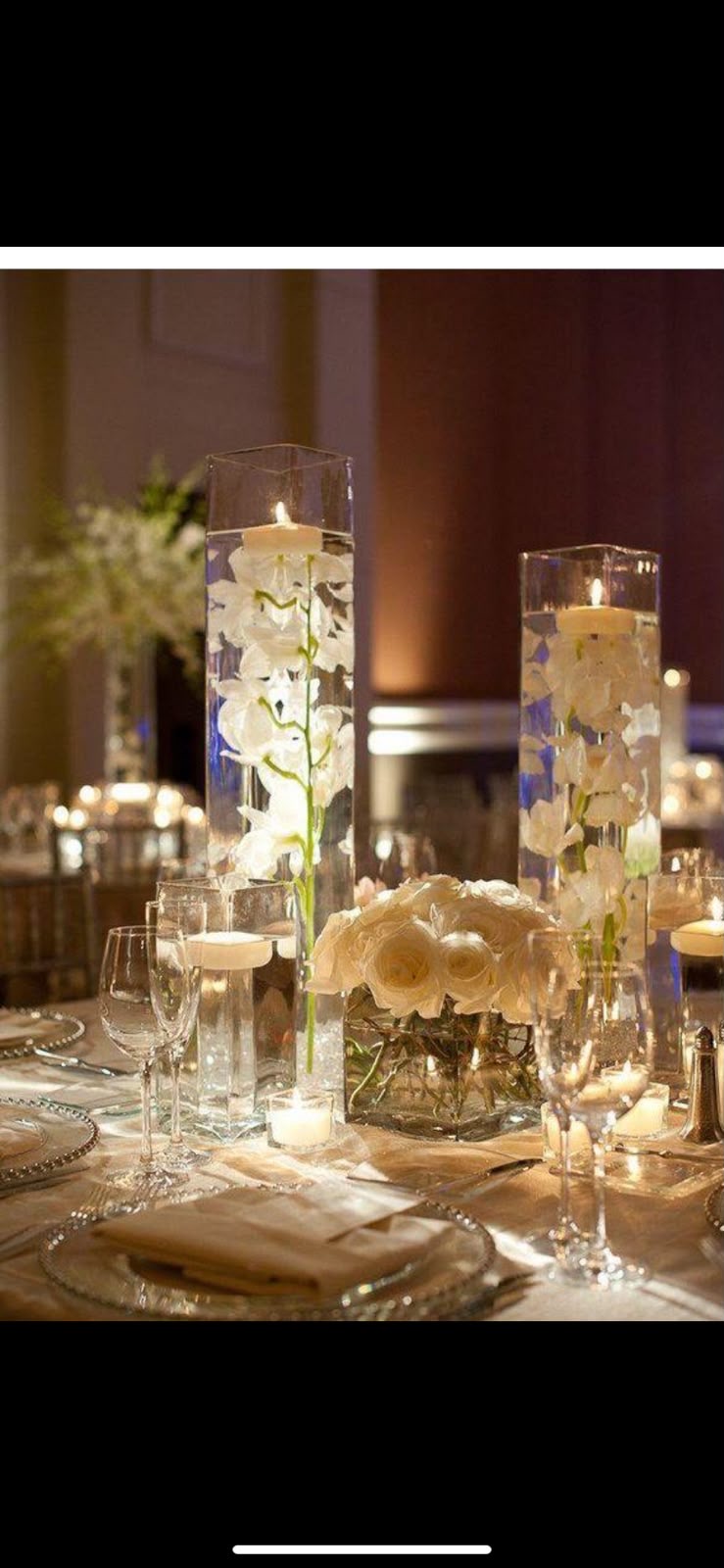 Submerged orchid tall vases with floating candles