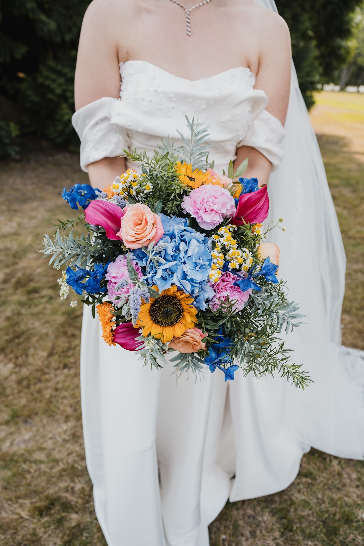 Bride holding vibrant wildflower bouquet